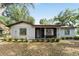 Inviting single-story home with a manicured front yard, showcasing its cozy curb appeal at 10060 Se 106Th Ln, Belleview, FL 34420