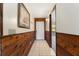 Hallway featuring wood paneling, a white tile floor, and artwork at 10060 Se 106Th Ln, Belleview, FL 34420