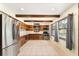 Well-lit kitchen featuring warm wood cabinets, stainless steel appliances, and plenty of natural light through multiple windows at 10060 Se 106Th Ln, Belleview, FL 34420