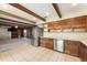 Open concept kitchen with wood cabinets, stainless steel appliances, and views into the cozy living space at 10060 Se 106Th Ln, Belleview, FL 34420