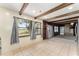 Bright kitchen with expansive views featuring stainless steel appliances and exposed ceiling beams at 10060 Se 106Th Ln, Belleview, FL 34420