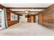 Expansive living area featuring wood paneling, beam ceilings, and a sliding barn door at 10060 Se 106Th Ln, Belleview, FL 34420