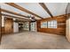 Open floor plan with wooden beam ceilings seamlessly connects the living room to the kitchen at 10060 Se 106Th Ln, Belleview, FL 34420