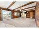 Spacious living room boasts wooden beams, wood paneling, and ample natural light at 10060 Se 106Th Ln, Belleview, FL 34420
