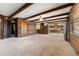 An open floor plan with wood beam ceilings showcasing the expansive living room and kitchen area at 10060 Se 106Th Ln, Belleview, FL 34420