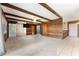 Large living space with wooden beam ceilings, sliding barn door, and a doorway to the entry at 10060 Se 106Th Ln, Belleview, FL 34420