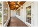 A screen enclosed back porch with wood ceiling and floors at 10060 Se 106Th Ln, Belleview, FL 34420