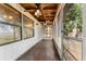 Large screened porch, with a wood ceiling and wood floor at 10060 Se 106Th Ln, Belleview, FL 34420