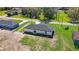 Aerial view of the backyard of a home with a dark roof and a well-manicured green lawn at 1062 Nw 69Th St, Ocala, FL 34474