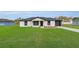 Beautiful front exterior features a well-manicured lawn, a paved driveway, and a garage at 1062 Nw 69Th St, Ocala, FL 34474