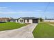 Charming home with a well-manicured lawn and a paved driveway leading to the garage at 1062 Nw 69Th St, Ocala, FL 34474