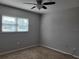 Bedroom featuring carpet, a ceiling fan, and a window at 11250 Sw 76Th Ave, Ocala, FL 34476