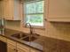 Kitchen featuring granite counters, a stainless steel sink, and white cabinets at 11250 Sw 76Th Ave, Ocala, FL 34476