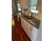 Well-lit kitchen featuring granite countertops and white cabinetry at 11250 Sw 76Th Ave, Ocala, FL 34476