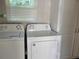 Well-equipped laundry room with washer, dryer, and storage space at 11250 Sw 76Th Ave, Ocala, FL 34476