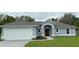 Charming single-story home featuring an attached garage and manicured lawn at 12864 Sw 40 Ter, Ocala, FL 34473