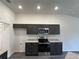 Modern kitchen boasts stainless steel appliances, granite counters, and sleek, dark cabinets at 12864 Sw 40 Ter, Ocala, FL 34473