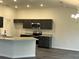 Modern kitchen with stainless steel appliances, granite countertops, and dark cabinetry at 12864 Sw 40 Ter, Ocala, FL 34473