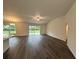 Bright living room with modern wood flooring and sliding glass doors to the backyard at 12864 Sw 40 Ter, Ocala, FL 34473