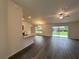 Open-concept living area featuring modern wood floors, vaulted ceilings, and sliding glass doors at 12864 Sw 40 Ter, Ocala, FL 34473