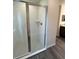 Modern glass enclosed shower with white tiled walls and floor, and chrome fixtures at 12864 Sw 40 Ter, Ocala, FL 34473