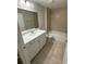 Modern bathroom with a bathtub, shower, and a well-lit vanity at 13714 Sw 114Th Pl, Dunnellon, FL 34432