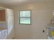 Unfinished basement with water heater, concrete walls, and storage at 1400 Ne 54Th St, Ocala, FL 34479
