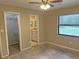 Cozy bedroom with neutral walls, a ceiling fan, and convenient access to a closet and bathroom at 1400 Ne 54Th St, Ocala, FL 34479