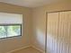 The bedroom has a window overlooking the yard, and a closet for storage at 1400 Ne 54Th St, Ocala, FL 34479