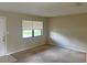 Bright living room featuring a large window and neutral-toned walls and carpet at 1400 Ne 54Th St, Ocala, FL 34479
