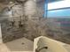 Stunning bathroom features a luxurious shower and a soaking tub, creating a spa-like retreat at 16331 Se 81St Ct, Summerfield, FL 34491