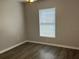 Bedroom with natural light from a window and plank floors, providing a clean and comfortable space at 16331 Se 81St Ct, Summerfield, FL 34491
