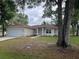 Charming single-story home features a well-maintained lawn and attached two car garage at 16331 Se 81St Ct, Summerfield, FL 34491