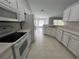 Spacious kitchen features white appliances, modern cabinetry, and tile flooring at 16331 Se 81St Ct, Summerfield, FL 34491
