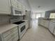 White kitchen features modern appliances, ample cabinet space, and tile flooring at 16331 Se 81St Ct, Summerfield, FL 34491