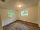 Cozy bedroom with updated vinyl floors, natural light, and a serene atmosphere, ideal for relaxation at 23177 Sw Beach Blvd, Dunnellon, FL 34431