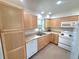 Bright kitchen with wood cabinets, a double sink, and white appliances providing a charming cooking space at 23177 Sw Beach Blvd, Dunnellon, FL 34431
