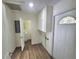 Functional laundry room features storage cabinets, a utility sink, and access to a bathroom at 23177 Sw Beach Blvd, Dunnellon, FL 34431