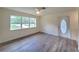 Bright living room with new vinyl floors and a large window overlooking the front yard at 23177 Sw Beach Blvd, Dunnellon, FL 34431