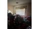 A messy bedroom with piles of clothes is shown in this listing image at 2323 Sw 3Rd St, Ocala, FL 34471