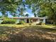 Modest single-story home with mature trees offering shade in the front yard at 2323 Sw 3Rd St, Ocala, FL 34471