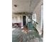 Covered porch area featuring a ramp for accessibility and a seating area at 2323 Sw 3Rd St, Ocala, FL 34471