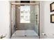 The tiled shower-tub combination features a glass enclosure and modern fixtures at 302 Se Broadway St # 330, Ocala, FL 34471