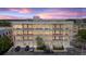 Stunning four-story building view at dusk, showcasing balcony-equipped residences and convenient parking at 302 Se Broadway St # 330, Ocala, FL 34471