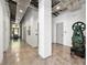 An open hallway with high ceilings, concrete floors, and an industrial vintage machine for decor at 302 Se Broadway St # 330, Ocala, FL 34471