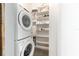 Convenient laundry area with stacked washer and dryer, and storage shelves for organization at 302 Se Broadway St # 330, Ocala, FL 34471