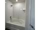 Bathroom with a white tiled shower-tub combination at 3474 Sw 155Th Pl, Ocala, FL 34473