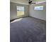 Spacious carpeted bedroom with natural light from two windows at 3474 Sw 155Th Pl, Ocala, FL 34473