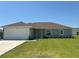 Charming single-story home with a well-manicured lawn and an attached two-car garage at 3474 Sw 155Th Pl, Ocala, FL 34473