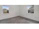 Carpeted bedroom with two windows providing natural light and white walls at 4246 Ne 32Nd Cir, Ocala, FL 34479